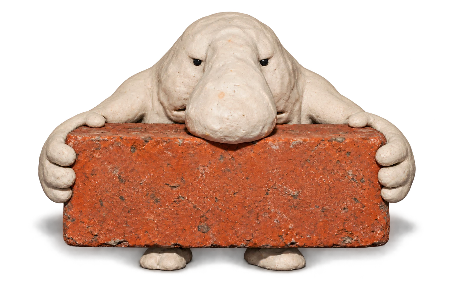 DORB hunches protectively over the same brick and grips it even tighter.